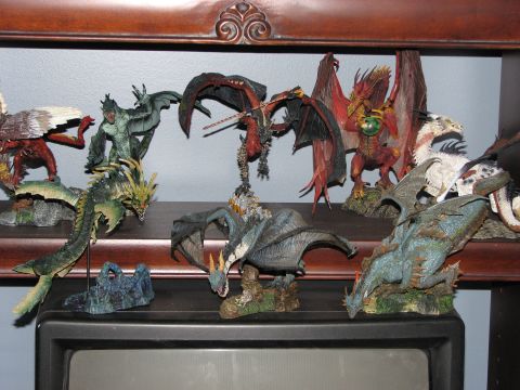 1991 Ford Bronco - Various dragon figurines are arranged on a wooden shelf, with a television visible below.