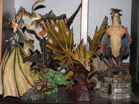1991 Ford Bronco - Several detailed dragon figurines are displayed on a shelf, some with wings spread.