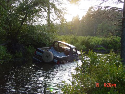 1995 Dodge 1500 - This 1995 Dodge 1500 is stuck in the water, with its rear half submerged.