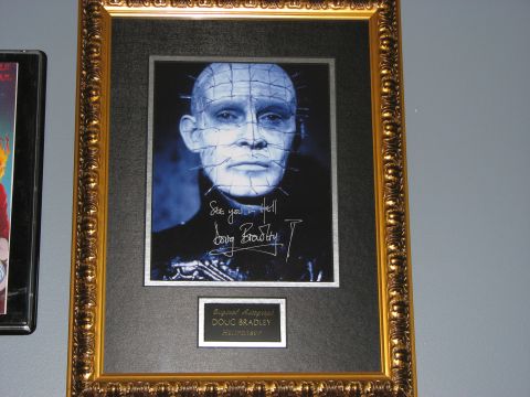 1991 Ford Bronco - A framed portrait of Pinhead, signed by actor Doug Bradley, is displayed on a wall.