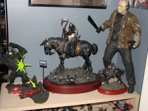 1991 Ford Bronco - A display of collectible toy figures Spawn, a Grim Reaper on horseback, and Jason Voorhees, set against a shelf.