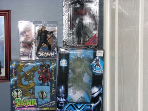 1991 Ford Bronco - Several collectible action figures, including Spawn and Predator characters, are displayed in their original packaging.