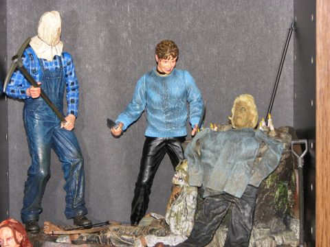 1991 Ford Bronco - A display of horror movie action figures, including characters with pickaxes and knives, set against a dark background.