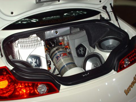 1995 Ford Probe - Custom car trunk features a powerful audio system and a nitrous oxide tank, extensive modifications.