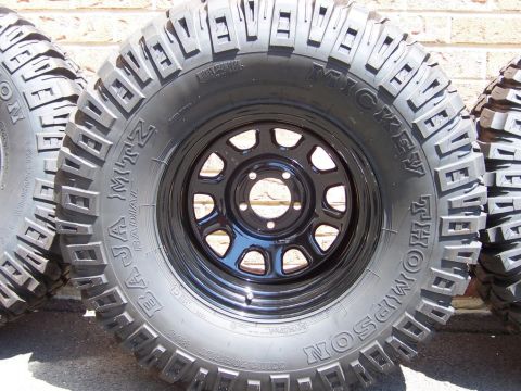1996 Jeep Grand Cherokee - Close-up of Mickey Thompson Baja MTZ radial tires and black rims.