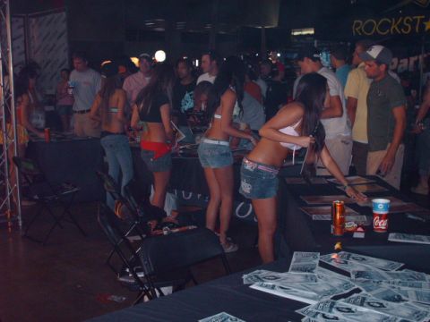 1995 Ford Probe - An indoor event with people browsing tables displaying documents and promotional materials.