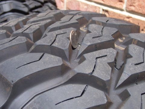 1996 Jeep Grand Cherokee - A dime is placed in the tread of a tire to show its depth.