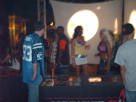 1995 Ford Probe - Attendees interact at a promotional event with tables displaying various items.