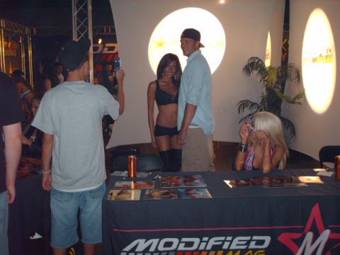 1995 Ford Probe - Promotional event with people posing for photos in front of a banner for "MODIFIED SUPERMOTORS".