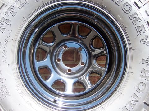 1996 Jeep Grand Cherokee - A chrome wheel with a Mickey Thompson Baja Radial tire is shown in a close-up view.