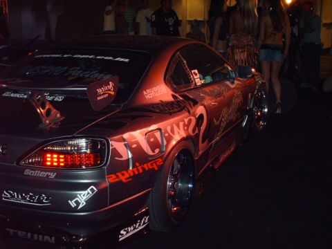 1995 Ford Probe - Customized Nissan Silvia S15 shows off its unique graphics and aftermarket spoiler at night.