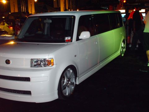 1995 Ford Probe - This white Scion xB is modified with aftermarket wheels and a body kit.