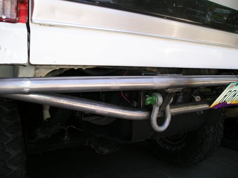 1993 Ford Bronco - Custom rear prerunner bumper with a green tow hook and shackle on a 1993 Ford Bronco.