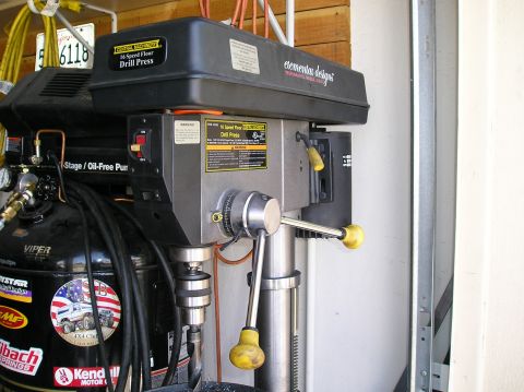 1993 Ford Bronco - Drill press and air compressor are visible in a garage setting with various stickers on the compressor.