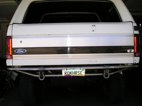 1993 Ford Bronco - The rear of a white Ford Bronco is shown, a custom bumper and an Arizona license plate.