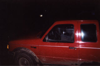 1997 Ford Ranger - Side view of a red 1997 Ford Ranger pickup truck captured in low light conditions.