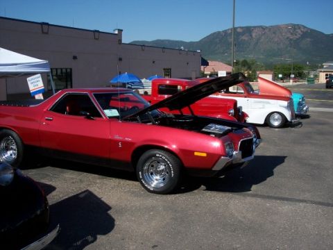 1972 Ford Ranchero - A red 1972 Ford Ranchero is displayed with its hood open at an outdoor event.