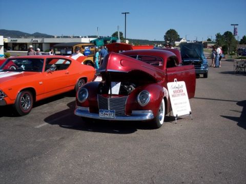 1972 Ford Ranchero - A custom-built 1939 Mercury Coupe is displayed at an outdoor car show with other vehicles.
