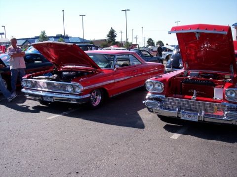 1972 Ford Ranchero - Two vintage American cars, a 1958 Cadillac and a Ford, are displayed with their engines exposed at an outdoor event.