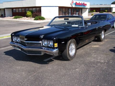 1972 Ford Ranchero - Black 1973 Chevrolet Impala convertible parked in front of Domino's Pizza.