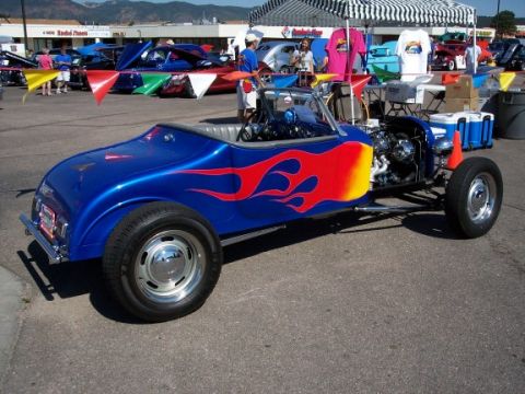 1972 Ford Ranchero - Custom hot rod with flame graphics parked at an outdoor event.