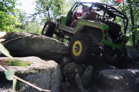 1976 GMC C/K Pickup - This off-road vehicle navigates a challenging rocky terrain.