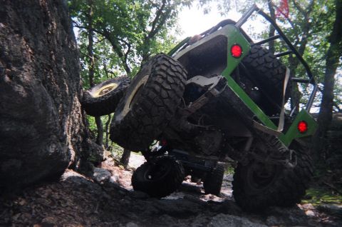 1976 GMC C/K Pickup - This custom off-road buggy is navigating a difficult rocky terrain, with another vehicle following closely.