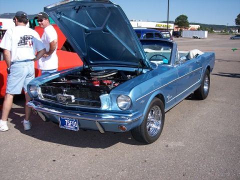 1972 Ford Ranchero - A classic blue convertible is displayed with its hood up, revealing the engine compartment.