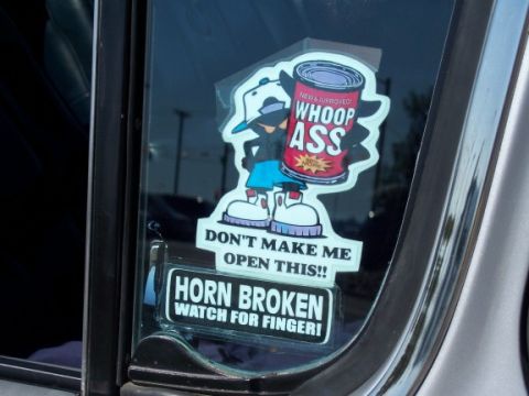 1972 Ford Ranchero - Stickers on a car window display humorous warnings.
