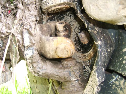 1993 Ford Bronco - Mud-caked suspension part, likely from an off-road vehicle.