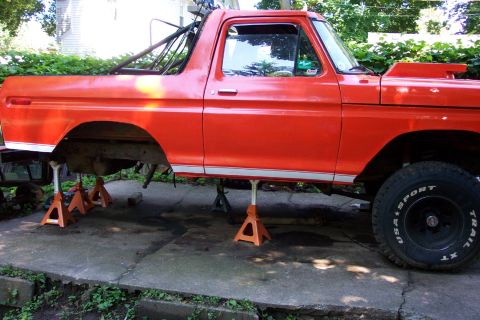 1978 Ford Bronco - This 1978 Ford Bronco is shown on jack stands, possibly undergoing maintenance or modification, with a distinctive custom hood scoop visibl…