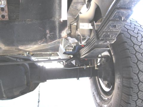 1994 Ford Bronco - Close-up of the rear suspension system, showing leaf springs and brake components.
