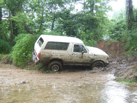 1993 Ford Bronco - White 1993 Ford Bronco stuck in mud and water off-road.
