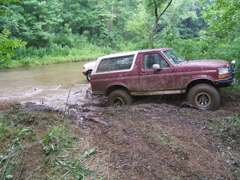 1993 Ford Bronco - This 1993 Ford Bronco is deeply stuck in the mud while attempting to cross a muddy stream.