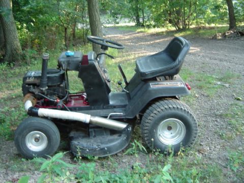 2002 Chevrolet Camaro - A modified lawn tractor sits outdoors, showing its engine and custom exhaust system.