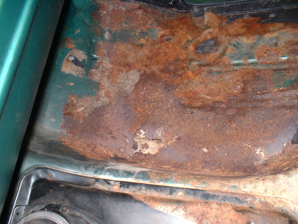 Rusted out passenger's side floor.
