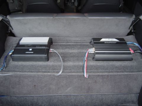 2002 Chevrolet Camaro - Two car amplifiers are installed in the trunk of a vehicle.