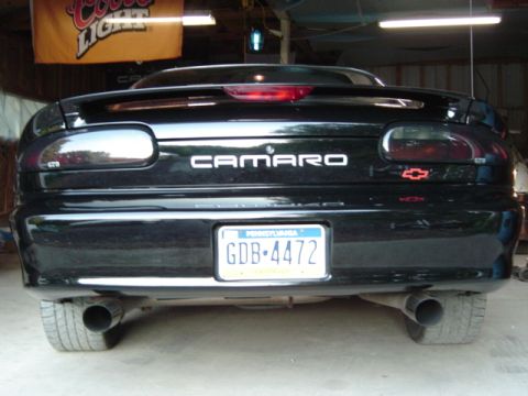 2002 Chevrolet Camaro - The rear of a black Chevrolet Camaro is shown, dual exhaust pipes and a spoiler.