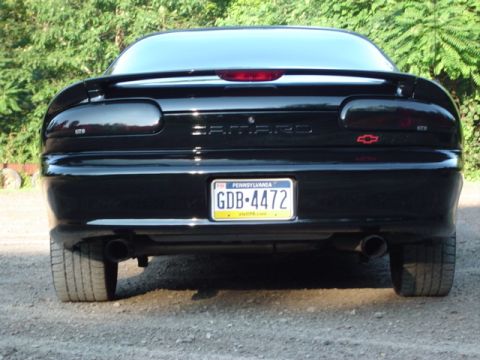 2002 Chevrolet Camaro - The rear of a black Chevrolet Camaro is shown, a Pennsylvania license plate and dual exhaust pipes.