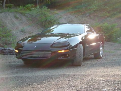 2002 Chevrolet Camaro - Front 3/4 view of a black 2002 Chevrolet Camaro with an aftermarket grille.