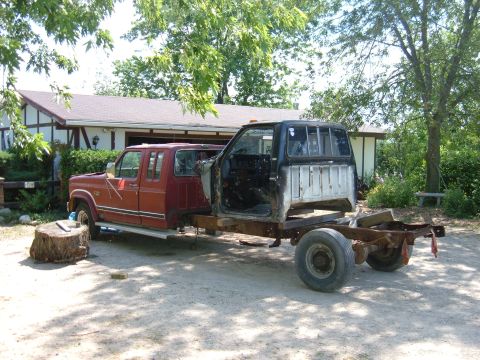 1985 Ford F-150 - This custom truck build features two cabs joined together, with the front cab appearing to be from a 1985 Ford F-150.