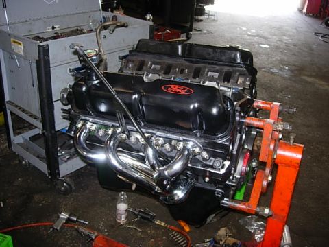 1993 Ford Bronco - Ford V8 engine on an engine stand in a workshop setting.