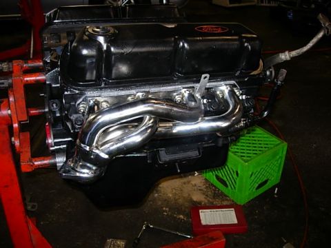 1993 Ford Bronco - A Ford V8 engine with shiny chrome headers is shown, possibly for a new engine installation.