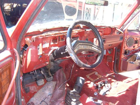 1985 Ford F-150 - The interior of a truck is shown with the dashboard disassembled, revealing the inner workings and wiring.