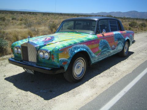1968 Ford Mustang - This Rolls-Royce features a vibrant, psychedelic mural depicting waves and a sunset, a stark contrast to its luxurious origins.