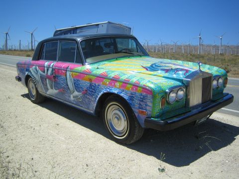 1968 Ford Mustang - This Rolls-Royce features a vibrant mural depicting birds and ocean waves, set against a backdrop of wind turbines.