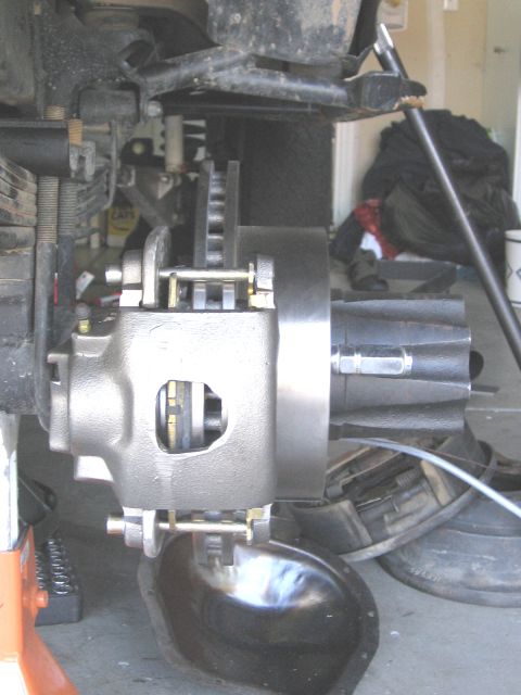 1994 Ford Bronco - This photo shows a close-up view of a vehicle's brake caliper and rotor assembly, likely during maintenance.
