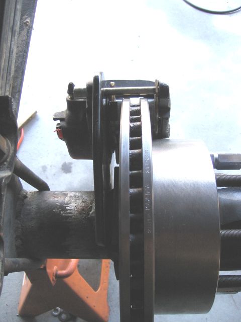 1994 Ford Bronco - Close-up view of a vehicle's disc brake assembly, showing the rotor and caliper.