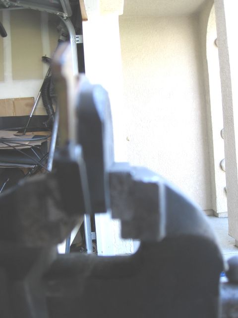 1994 Ford Bronco - A metal vise is holding a part in focus, with a garage interior in the background.