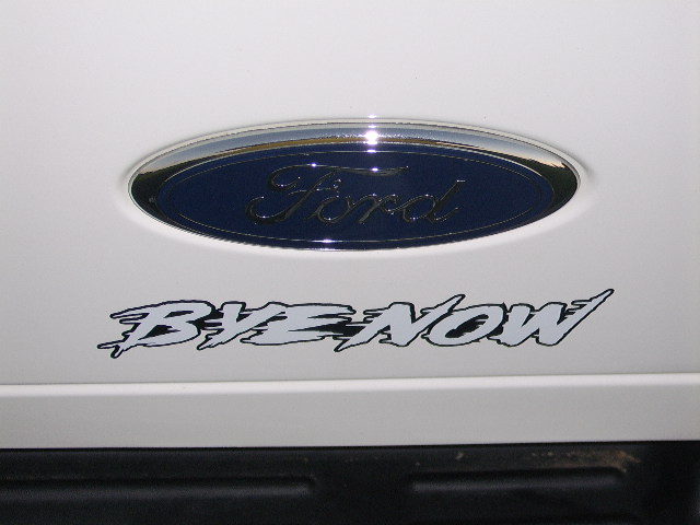Ford blue oval emblem on white panel with 'BYE NOW' decal below it